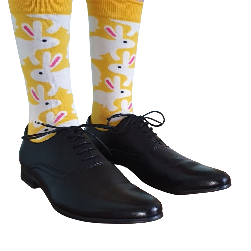 Male Model wearing yellow socks with a rabbit print and black formal shoes