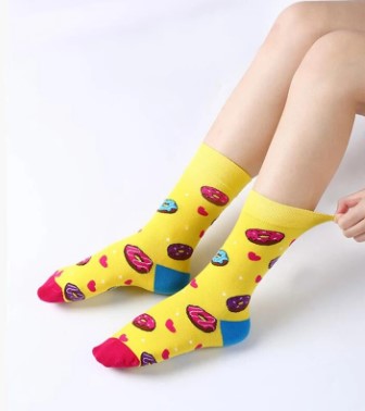 Yellow socks with colorful donut print worn by model