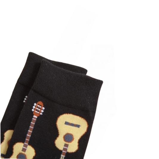 Close up view of black socks with guitar print laid flat