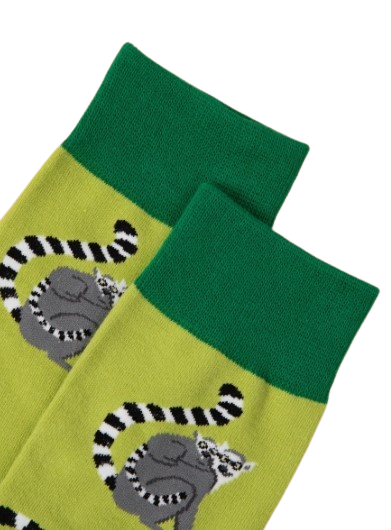 Closeup of dark green cuff of lime green lemur socks laid flat