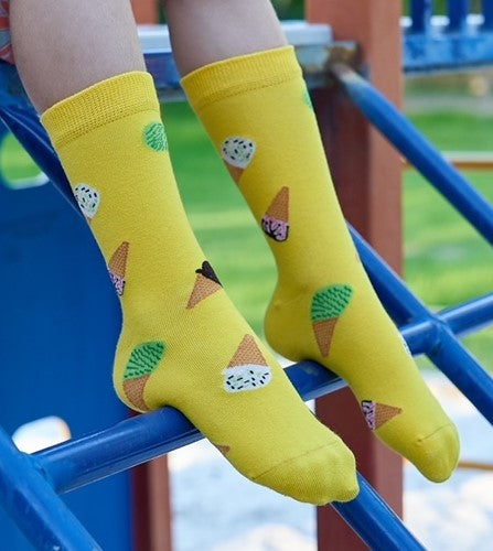 Fun summer socks for kids shoe size 13–3 – Ice Cream design worn by model in playground