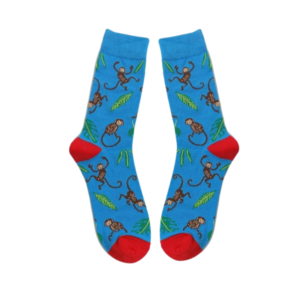 Blue socks with monkeys and leaves laid flat on a white background
