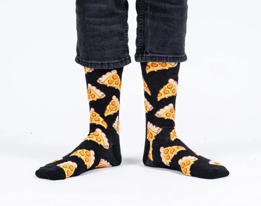 Black socks with pizza pattern worn by a person on a white background