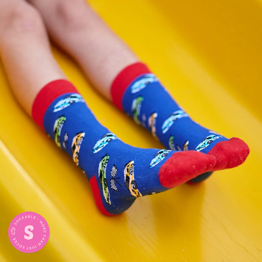 Race car socks for kids worn by child in playground
