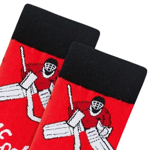 Close up of black cuff on red hockey socks laid flat