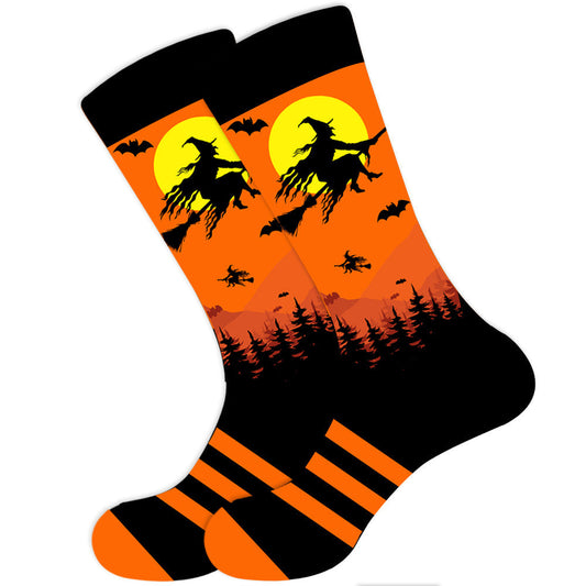 A pair of orange and black socks with a graphic of a witch on a broomstick in a Halloween-themed design.