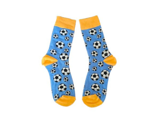 A pair of blue crew socks with a black and white soccer ball pattern, featuring yellow toes, heels, and cuffs, displayed against a plain white background.