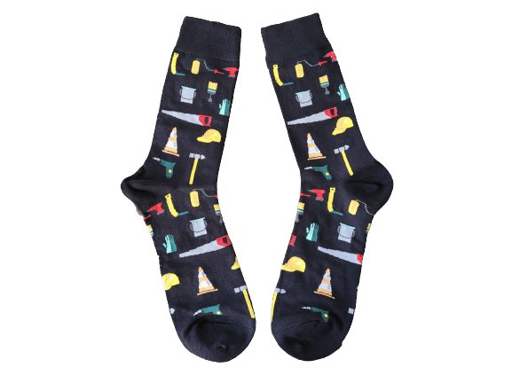Black socks with different tools laid flat on a white background