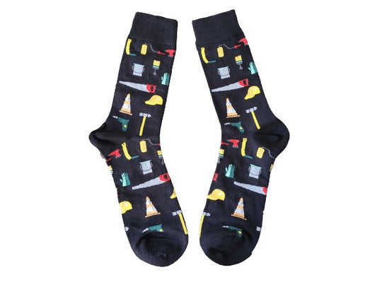 Black socks with different tools laid flat on a white background
