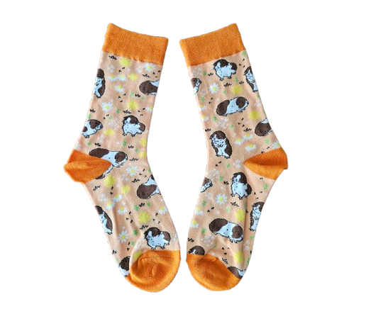 Pair of socks with guinea pig pattern and orange accents