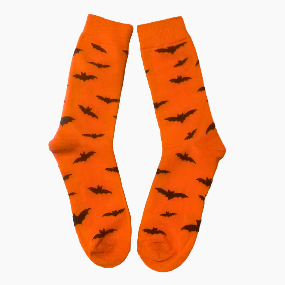 Orange socks with black bat patterns on a white background