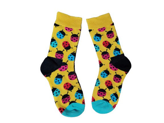 Pair of socks with ladybug pattern on a yellow background
