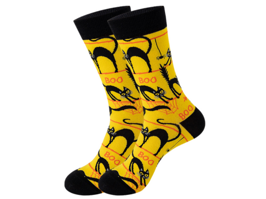 A pair of yellow socks with a pattern of cat faces and the word 'BOO!' displayed.