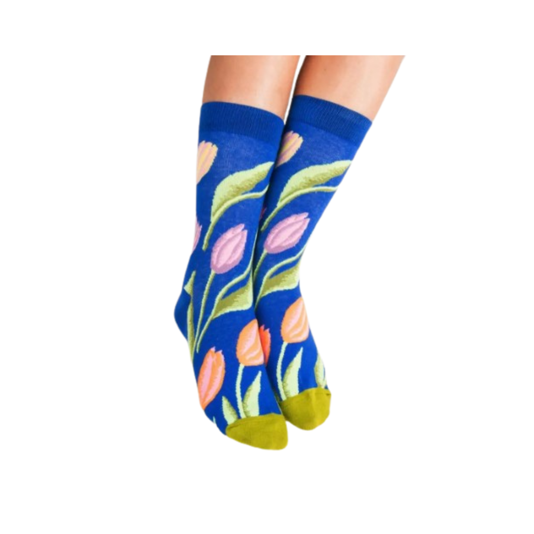 Blue socks with floral tulip design worn by a model on a white background