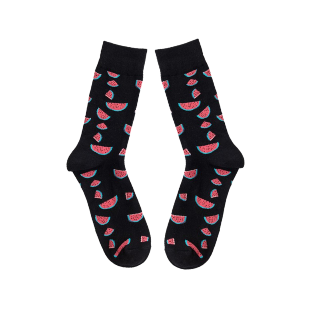 Black socks with slices of watermelon laid flat on white background
