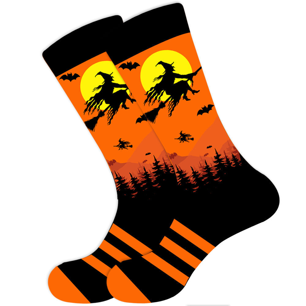 A pair of orange and black socks with a graphic of a witch on a broomstick in a Halloween-themed design.